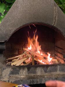 a brick oven with a fire in it at Calisto Villas Arapya in Arapya