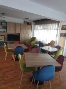 a group of tables and chairs in a room at Poarta Apelor in Sarichioi