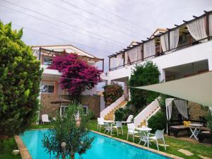 The swimming pool at or close to Michaella's Maissonete at Rafaella Resort Még 17 kép