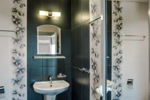 a bathroom with a sink and a mirror at Calisto Villas Arapya in Arapya +77 photos