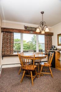 a dining room with a table and chairs and a window at Manchester View in Manchester