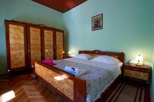 a bedroom with a large bed and two night stands at Apartman Ivan in Drniš