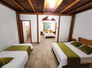 a bedroom with two beds in a room at Tuzco Lodge in Puerto López