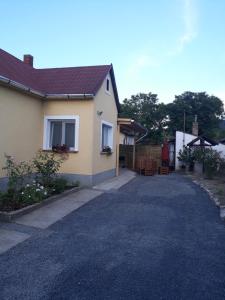 a house with a driveway in front of it at Kuckó Apartman in Badacsonytördemic