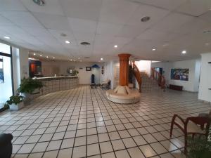 a lobby with a clock in the middle of a building at Hotel Jaime I in Peñíscola