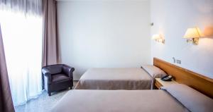 Postel nebo postele na pokoji v ubytování Hotel Leuka