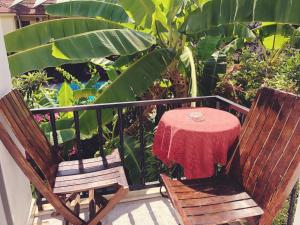 a table with a red table cloth sitting on a balcony at Dove Apart Hotel in Fethiye
