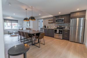 a kitchen with a table and a dining room at Basecamp Suites Canmore in Canmore