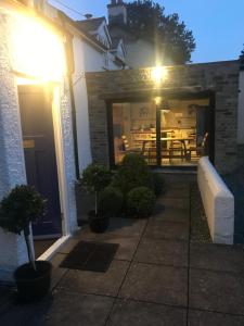 a building with a patio with a table in it at Chapel House Cottage in Builth Wells