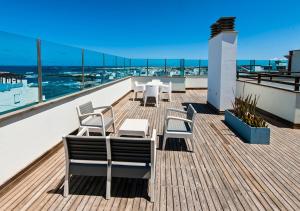 balkon z krzesłami i stołami na dachu w obiekcie Casa Rafa w mieście Cotillo
