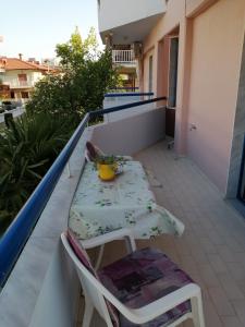 a table and chairs sitting on a balcony at Hotel Eleni in Paralia Dionysiou