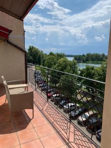 a balcony with chairs and a view of a river at Apartamenty nad jeziorem in Ełk
