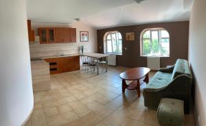 a kitchen and living room with a couch and a table at Apartamenty nad jeziorem in Ełk