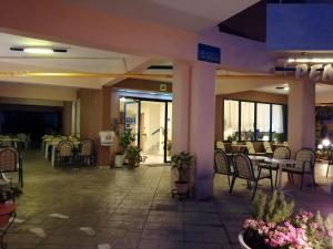 a lobby of a hotel with tables and chairs at Hotel Eleni in Paralia Dionysiou
