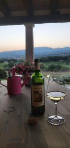 uma garrafa de vinho e um copo sobre uma mesa em Cantina Perandria em Monti