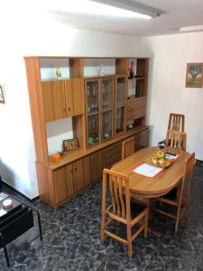 a kitchen with a wooden table and chairs at Caseta del Delta de l'Ebre in Sant Jaume d'Enveja +23 photos