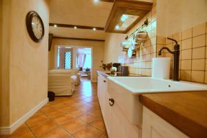 a kitchen with a sink and a clock on the wall at Apartament Rustical in Wrocław