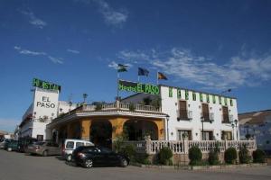 a large white building with flags on top of it at Hostal Restaurante El Paso in Bailén