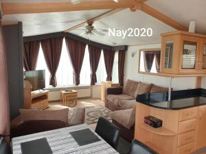 a living room with a couch and a table at Fantasy Lodge Sunnymede in Ingoldmells