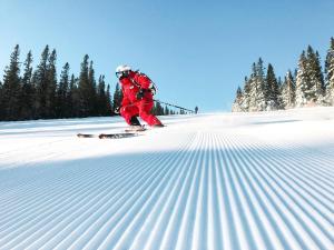 a person is skiing down a snow covered slope at Gula Byn 411A in Sälen