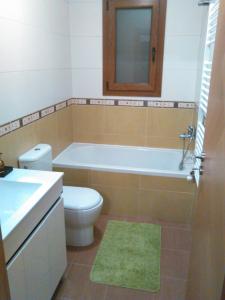 a bathroom with a tub and a toilet and a sink at Casa das Argolas in Macedo de Cavaleiros