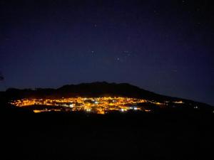 a view of a city at night with a mountain at Casa Lela II in Fuencaliente de la Palma