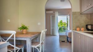 a kitchen and dining room with a table and chairs at Beachfront Suites Lourdas in Lourdata +25 photos