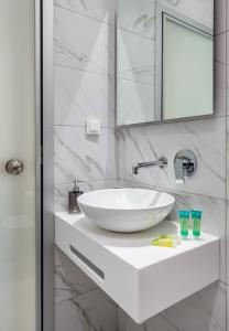 a bathroom with a white sink and a mirror at Green Velvet Thassos in Pefkari