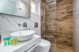 a bathroom with a sink and a toilet and a shower at Green Velvet Thassos in Pefkari