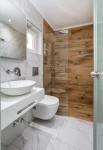 a bathroom with a toilet and a sink and a shower at Green Velvet Thassos in Pefkari