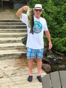 a man holding a fish in his hand at Somerset Lakeside Resort in Bancroft