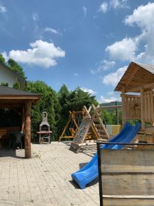 a playground with a slide and a swing set at Pokoje i apartamenty Aga Centrum in Wisła
