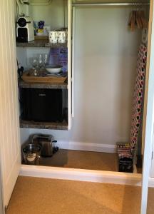 a pantry with a door open to a kitchen at Field's Edge in Swinderby +27 photos
