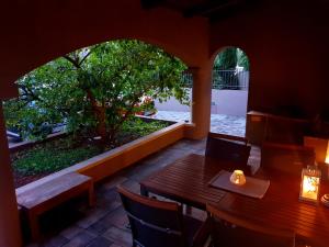 a restaurant with a table and chairs and a tree at Sfinga apartment in Zadar