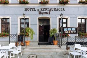 a hotel and restaurant with white tables and chairs at Hotel Legenda in Toruń +80 photos