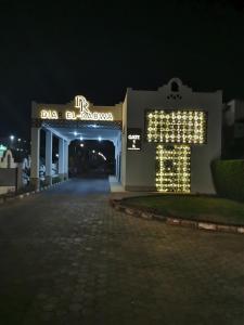 un edificio con un letrero iluminado por la noche en Chic Apartment 1, en Sharm El Sheikh