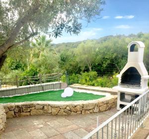 a pool of green water with a duck in it at International House San Teodoro in San Teodoro