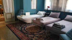 a room with two beds and a rug at MyDre@mSavona in Savona