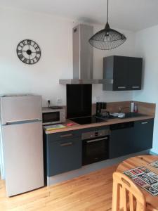 uma cozinha com um frigorífico branco e um fogão em Les Néréides em Mers-les-Bains