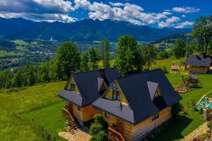 an aerial view of a house on a hill at Domki Widokowe Wooden Luxury Chalet in Ząb