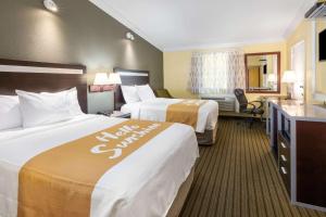 A bed or beds in a room at Days Inn by Wyndham Nanuet / Spring Valley