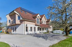 a large house with a driveway in front of it at Hostel Delalut in Ravne na Koroškem