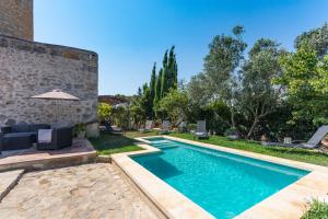 a swimming pool in the backyard of a house at Molí D,en Barret in Santa Margalida
