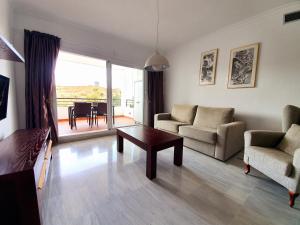 a living room with a couch and chairs and a table at Vista Alhaurin Golf in Alhaurín el Grande