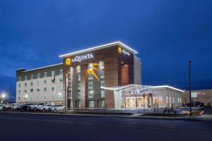 a large building with aania sign on the side of it at La Quinta by Wyndham Madera in Madera