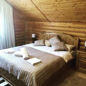 a bedroom with a bed with two towels on it at Gostynnyi Dvir VIP HOUSE in Migovo