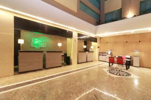 a hotel lobby with red chairs and a table at Holiday Inn Mexico City - Trade Center, an IHG Hotel in Mexico City