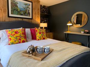 a tray on a bed with two mugs on it at Sherlocks lodgings in Whitby