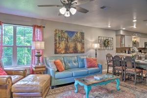 a living room with a blue couch and a table at Stylish Resort Condo 3 Mi to Downtown Branson! in Branson