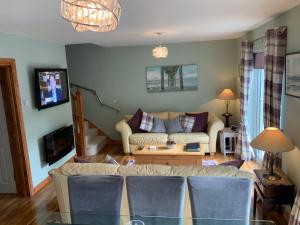 a living room with a couch and a tv at Lindfields in Inverness